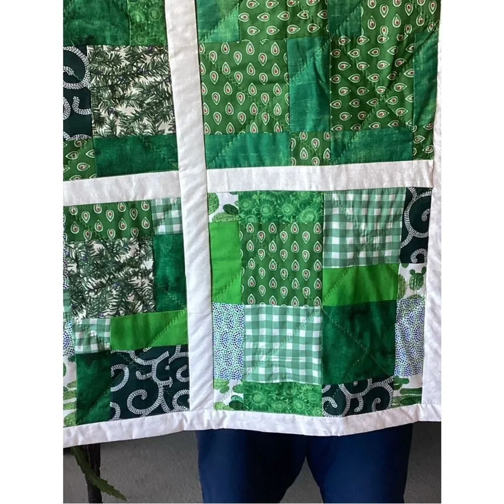 New without tags. Medley of Green Fabrics with White Borders Quilt